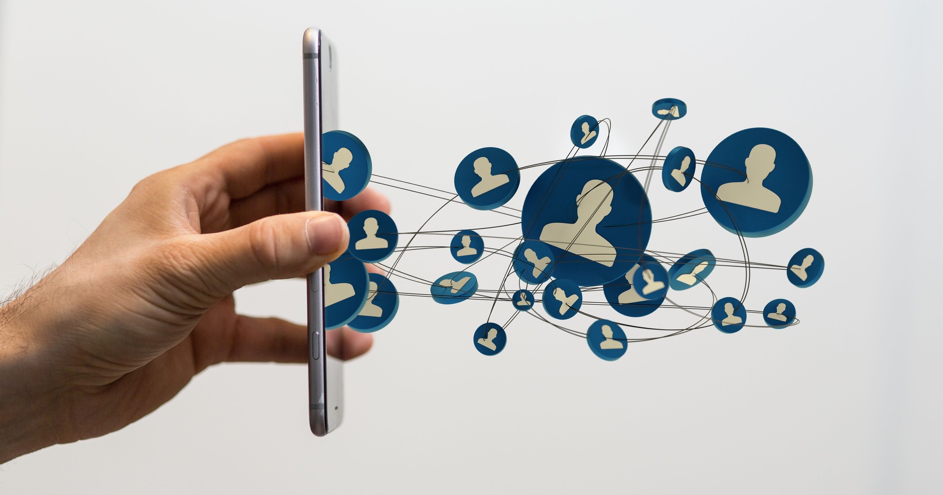 3D rendering of people silhouettes in the network team and a smartphone in a person's hand